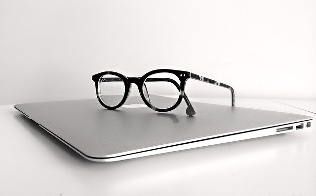 Glasses sitting on top of a laptop